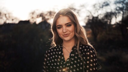 Naklejka premium half length portrait of young happy woman walking in the street on sunset.
