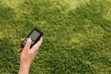 Girl Holds An Old Button Phone In Her Hand