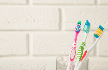 Toothbrushes in glass on light background tools for oral care