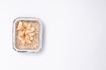 healthy food delivery or takeaway lunch box with oatmeal and apple in container