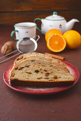 Christmas Stollen - homemade cake with sweet dried fruits,  raisins, orange pieces for lunch with black tea