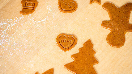 Gingear bread cookie in shape of hart with name love on it.