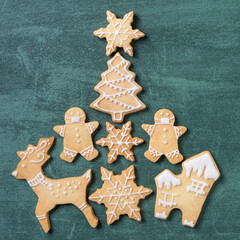 Fototapeta na wymiar Top view of Christmas tree and snowflake cooikes with gingerbread man wearing mask.