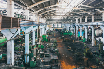 Fototapeta premium An abandoned old large industrial hall is waiting to be demolished. Former Khabarovsk plant for the production of diesel engines.