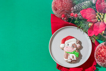 Christmas gingerbread in glaze in the form of a bull. Christmas symbols, on table with New Year's decor.