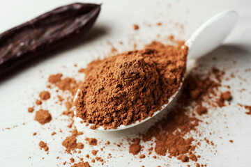 carob powder and ripe carob pod