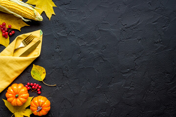Thanksgiving table setting with cutlery pumpkins and autumn leaves