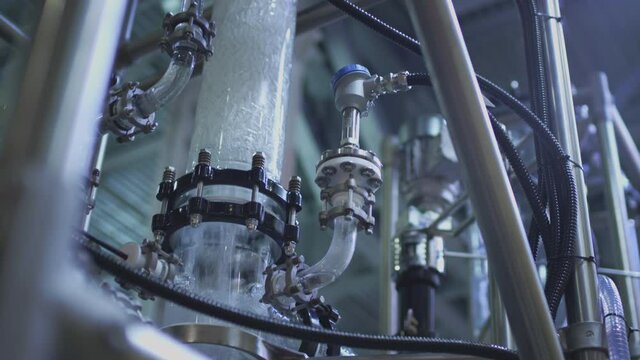 Water pump and pipes. Transparent pipe to show water flows inside the water supply system.