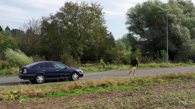 View of an athlete pulling a car