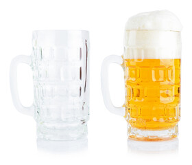 Two glasses, one empty and one filled with beer. Studio photo isolated on white background. Reflective surface.