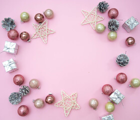 Christmas composition. Christmas decorations on a pastel pink background. Balls, cones, stars. 2021. Flat stacking, top view, copy space