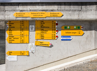 Mountain signposts at the wall in Sankt Niklaus city in swiss Alps
