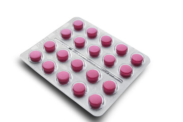 Aluminum foil-covered blister pack with pink tablets isolated on a white background