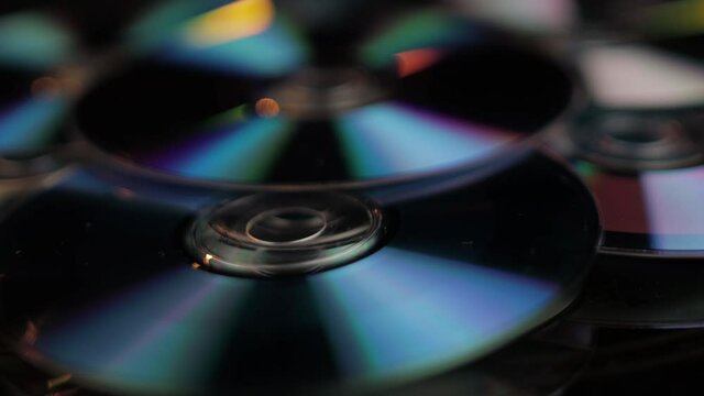 Close Up of CD and DVD Recordable Digital Media, Vintage Data and Video Storage. Full Frame Spinning