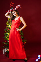 Naklejka premium Christmas Santa. Beautiful smiling woman model. Makeup. Healthy long hair style.