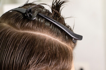 Obraz premium Cutting and styling dark hair, wet hair, hairdresser, close up