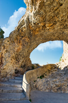 Staircase under arch and bridge of natural rock formation in the viewpoint of el Ventano del Diablo in Cuenca