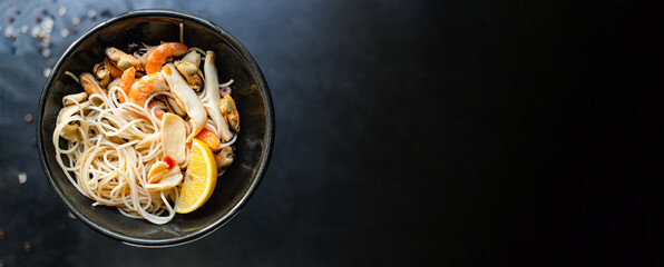 rice noodles cellophane pasta seafood shrimp, mussels, squid healthy pho soup meal poke snack top view copy space for text food background rustic