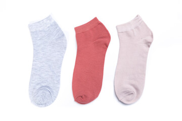 several colored new short socks on a white background, top view