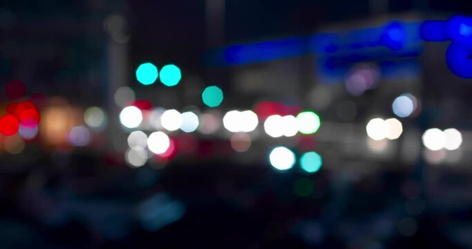 Urban transport in defocus at night. Bokeh of cars and traffic lights at night. Bokeh of City Night Traffic. Round colorful bokeh shine from car lights in traffic jam on city street. 