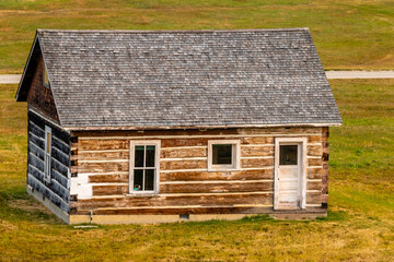 Fototapeta na wymiar Rustic farm buildings and equipment. Bar U Ranch National Historic Site, Alberta, Canada