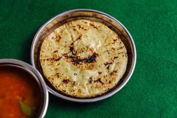 Fresh Homemade Indian Corn Bread with spicy black gram pulse recipe. Makki ki Roti And Urad Dahl.