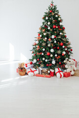 Fototapeta na wymiar New Year's Interior Christmas Tree with holiday postcard decor gifts