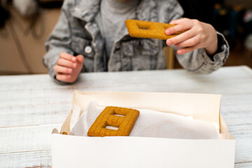 The boy makes a gingerbread house. Preparing for the holiday, creative activity.