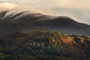 Clouds rolling over mountains on an Autumn morning in the Lake District, UK.