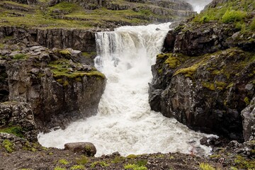 The landscape with Nykurhylsfoss (Sveinsstekksfoss) waterfall in Fossardalur, Iceland