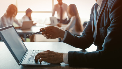 Holding pen male freelancer pointing computer screen showing his coworker updates he made....