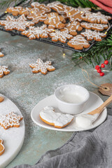 Bright Christmas or New Year wooden background with fir branches, Christmas decorations, Christmas gingerbread cookies, Christmas sweets.