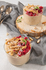 Breakfast oatmeal porridge with raspberries, almond, cinnamon, almond butter and coconut. Healthy breakfast delicious homemade english breakfast concept