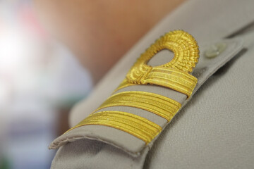Closeup epaulet or shoulder strap on the shoulder of a Thai government teacher.  Civil Servant...