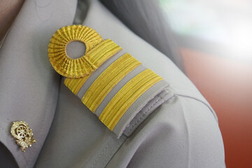 Level thai government civil servant shoulder strap on the shoulders of a Thai teacher.