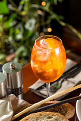 Aperol Spritz Cocktail Alcoholic beverage with ice cubes and oranges on the table at restaurant