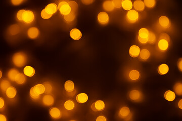 Abstract background, orange bokeh on a black background.
