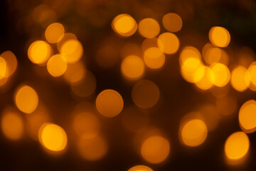 Abstract background, orange bokeh on a black background.