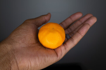 orange in palm of hand