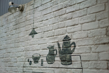 Pots, jugs, cups and lamps drawn on the wall