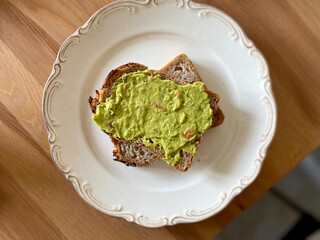 Mash Avocado dip or Mashed Guacamole Puree with Toast Bread for Breakfast in Plate.