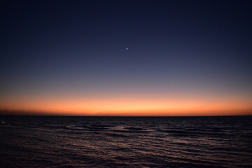 Sunset and crescent over the Red Sea, Jeddah, Saudi Arabia 