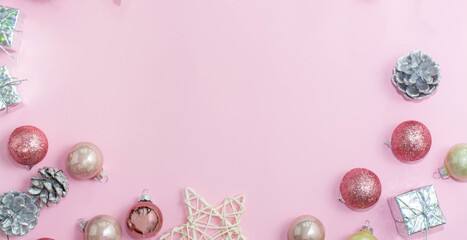 Christmas composition. Christmas decorations on a pastel pink background. Balls, cones, stars. 2021. Flat stacking, top view, copy space
