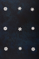 Beautiful dark Christmas background. Snowflakes.