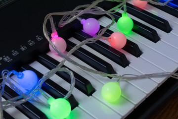 Musical background. Piano with colorful garland.