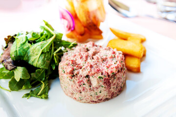 Tasty Steak tartare (Raw beef) - classic steak tartare on white plate