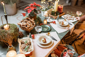 Beautifully decorated dinner table on the terrace outdoors during the New Year holidays