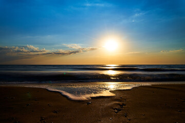 Fototapeta na wymiar Sea sunset. Quiet calm sea. Sand beach.