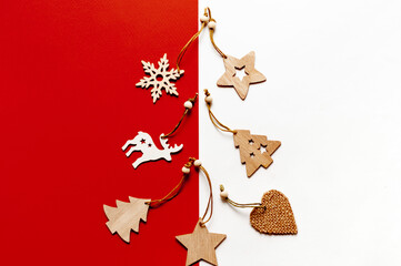 Wooden Christmas toys on a red and white background.Christmas or new year background with space for text.