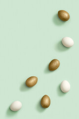 Decorated Easter golden and white eggs on green background. Happy Easter card, postcard